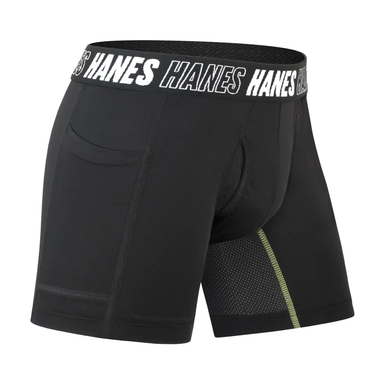 A black performance boxer brief cut out on white, its Hanes-lettered waistband straight, with a green stitch line and a mesh panel picked out along the leg.