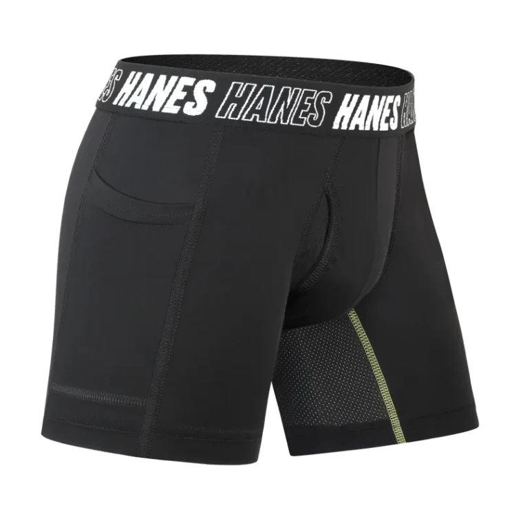 A black performance boxer brief rendered on a black background, with a branded elastic waistband and a mesh panel picked out along the leg.