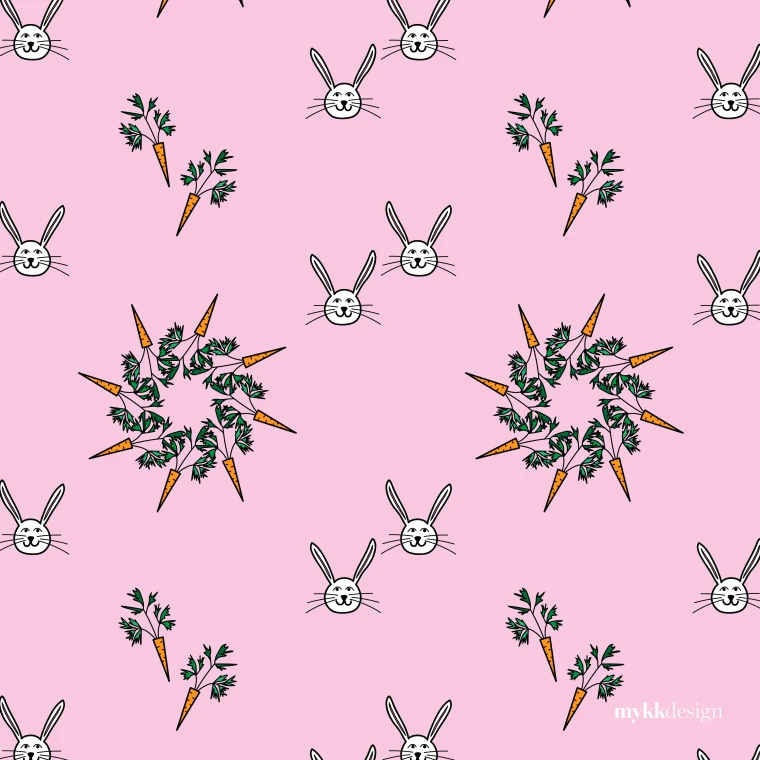 A pattern on pink of outlined white rabbit faces with long ears, drawn carrots with green tops, and rosettes formed by carrots arranged in a ring around their leaves.