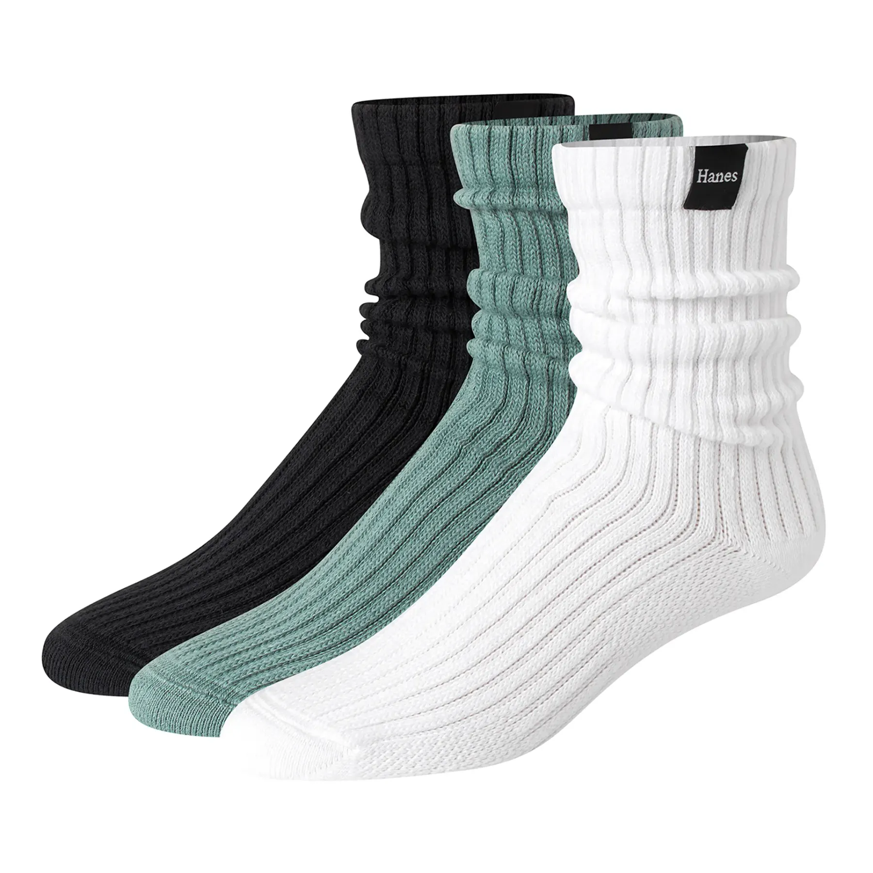 Three ribbed slouch crew socks standing upright side by side on white, in black, sage green and white, each with a small woven label at the cuff.