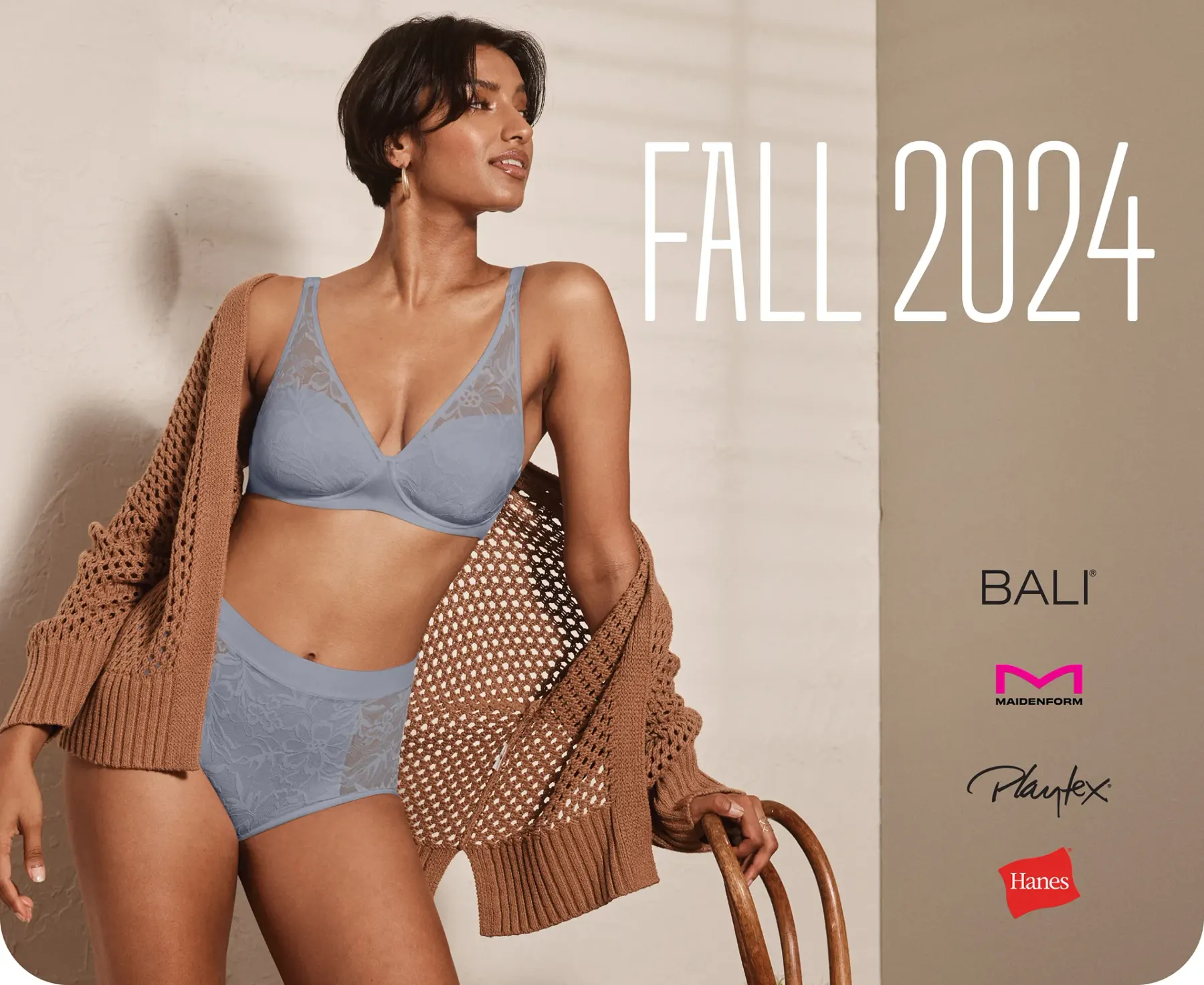 A seasonal board headed Fall 2024: a woman standing beside a wooden chair in a pale blue bra and briefs with a tan cardigan over her shoulders, and the Bali, Maidenform, Playtex and Hanes marks stacked at the right.