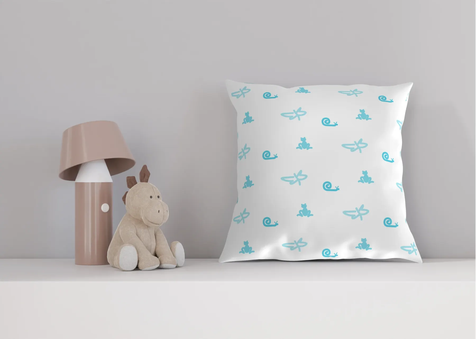 The pattern printed on a white cushion standing on a pale shelf, beside a soft toy and a dusty-pink table lamp.